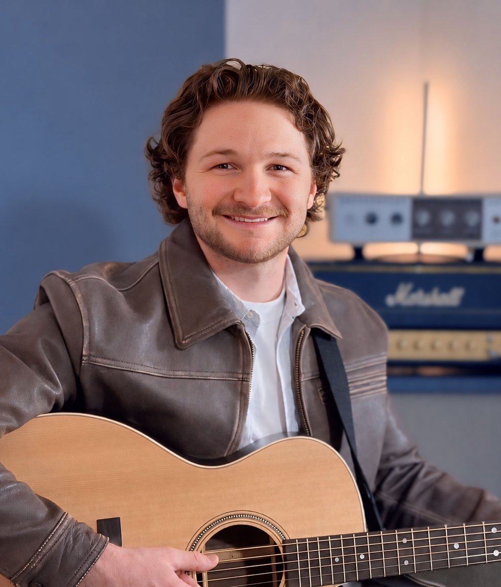 Corbin holding an acoustic guitar